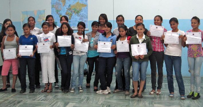 Girls with certificates from Good For Kids' early work